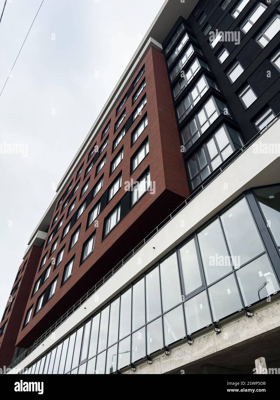 Urban city apartment building with glass windows and elegant design reflecting contemporary style Stock Photo