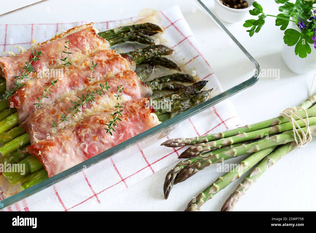 Homemade baked asparagus rolls with cooked ham and cheese. Spring food ...