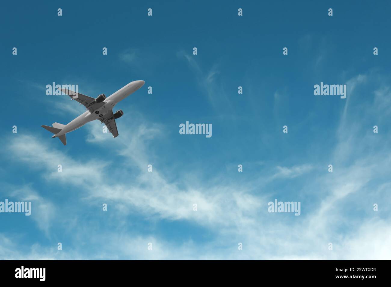 Airplane flying in beautiful blue sky with clouds Stock Photo - Alamy