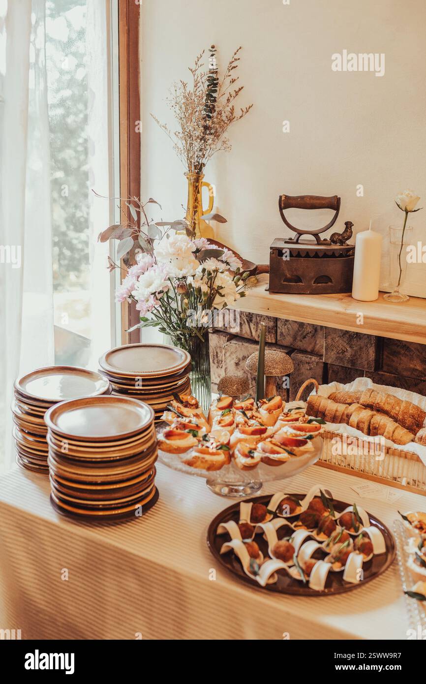 An inviting display of appetizers and cutlery in a rustic and cozy setting. Stock Photo