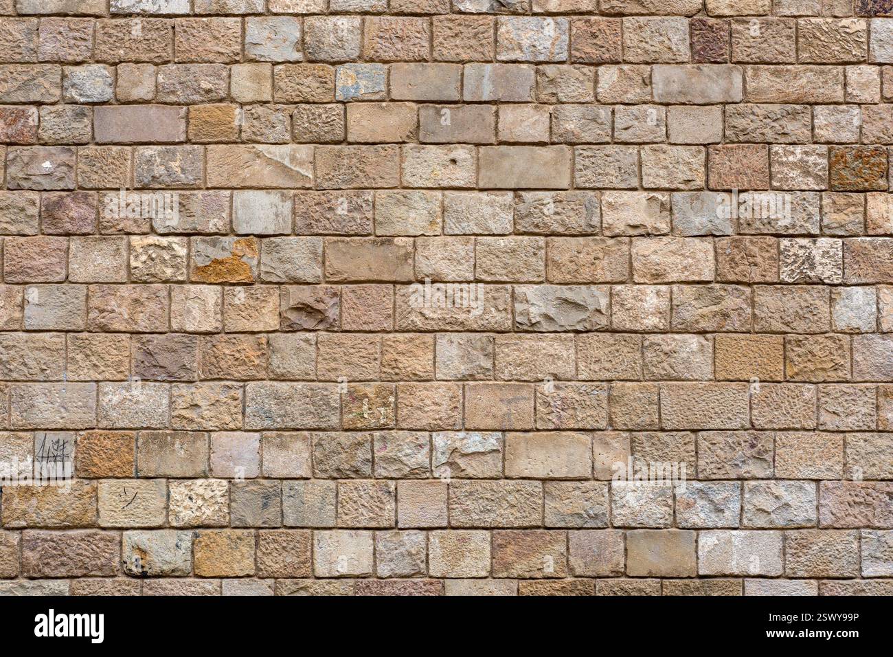 Background from a uniform natural stone wall Stock Photo
