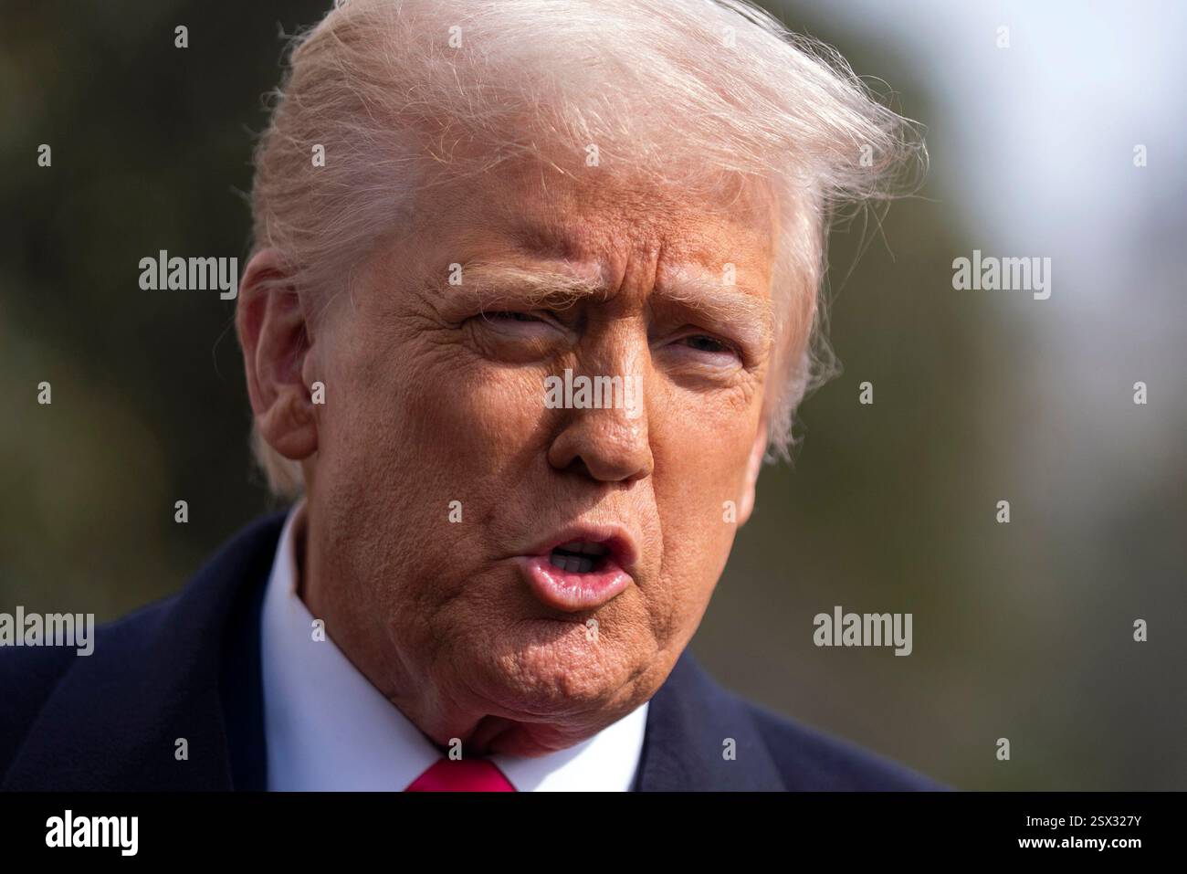 President Donald Trump speaks to reporters before leaving the White ...