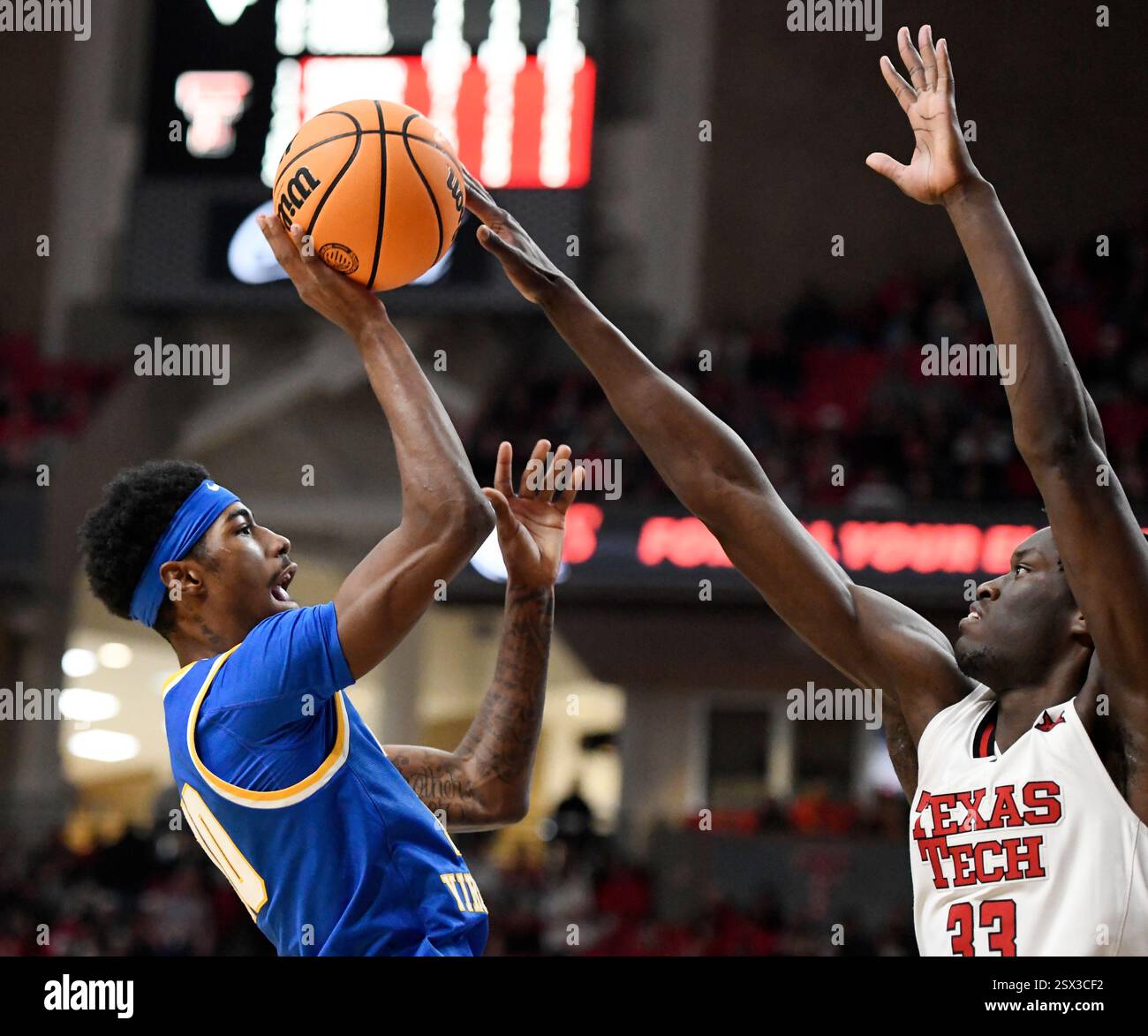 West Virginia guard Sencire Harris, left, has his shot blocked by Texas ...