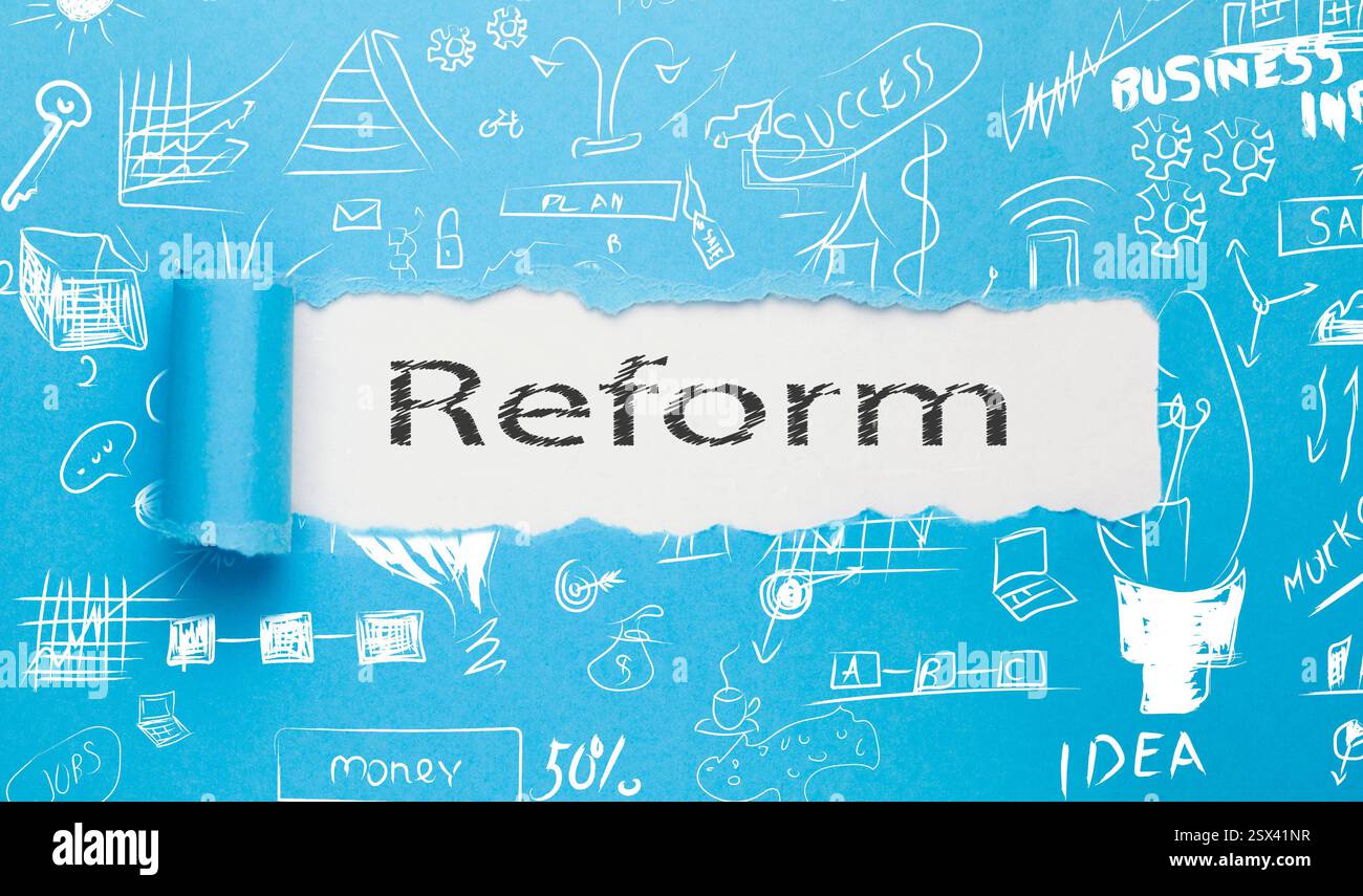 reform text written paper on blue background Stock Photo