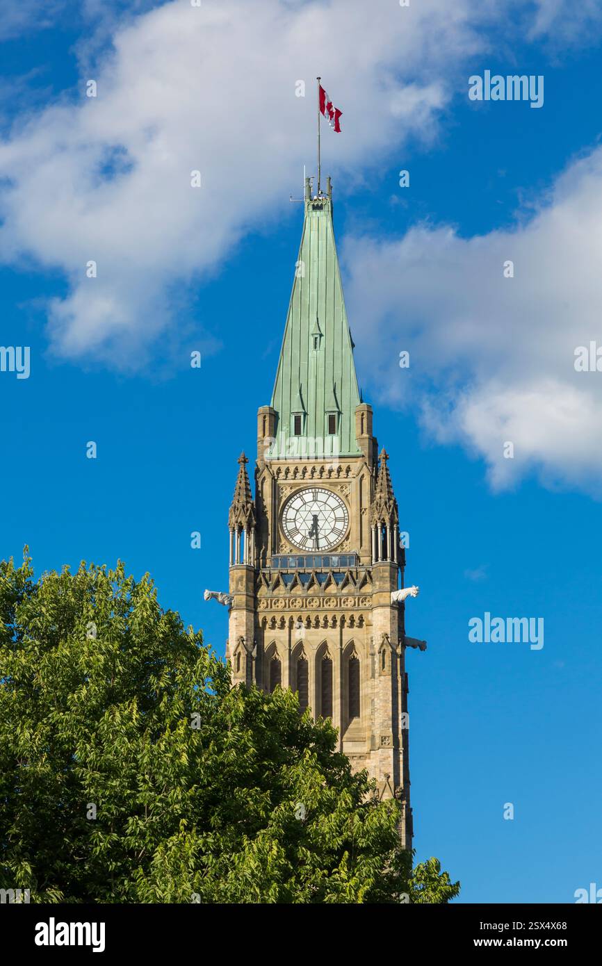 Large clock tower with a red and white flag on top. The clock is set at ...