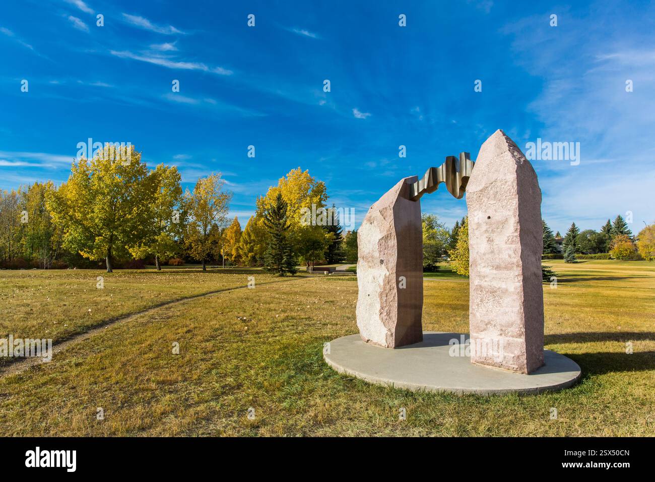 Large stone sculpture is in the middle of a grassy field. The sculpture ...