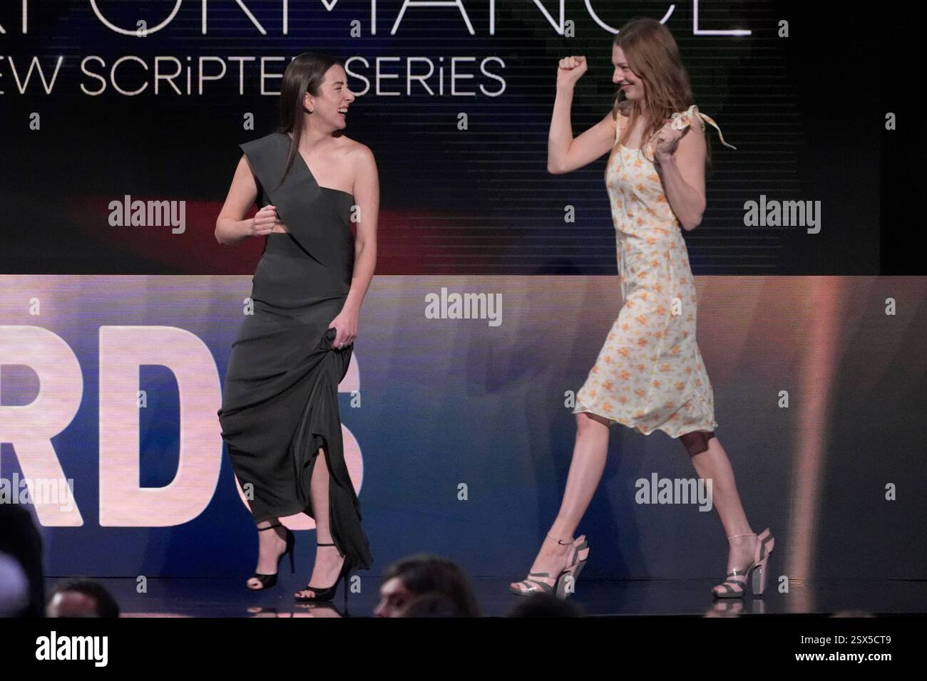 Alana Haim, left, and Hunter Schafer appear on stage to present the ...