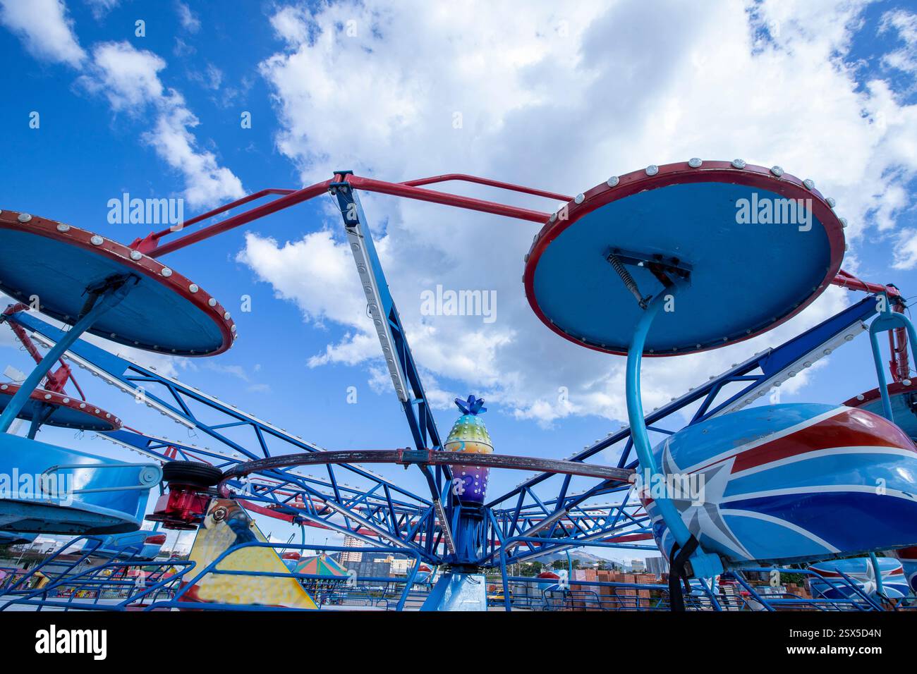 multicolored carrousel in a traveling amusement park. Countryside of ...