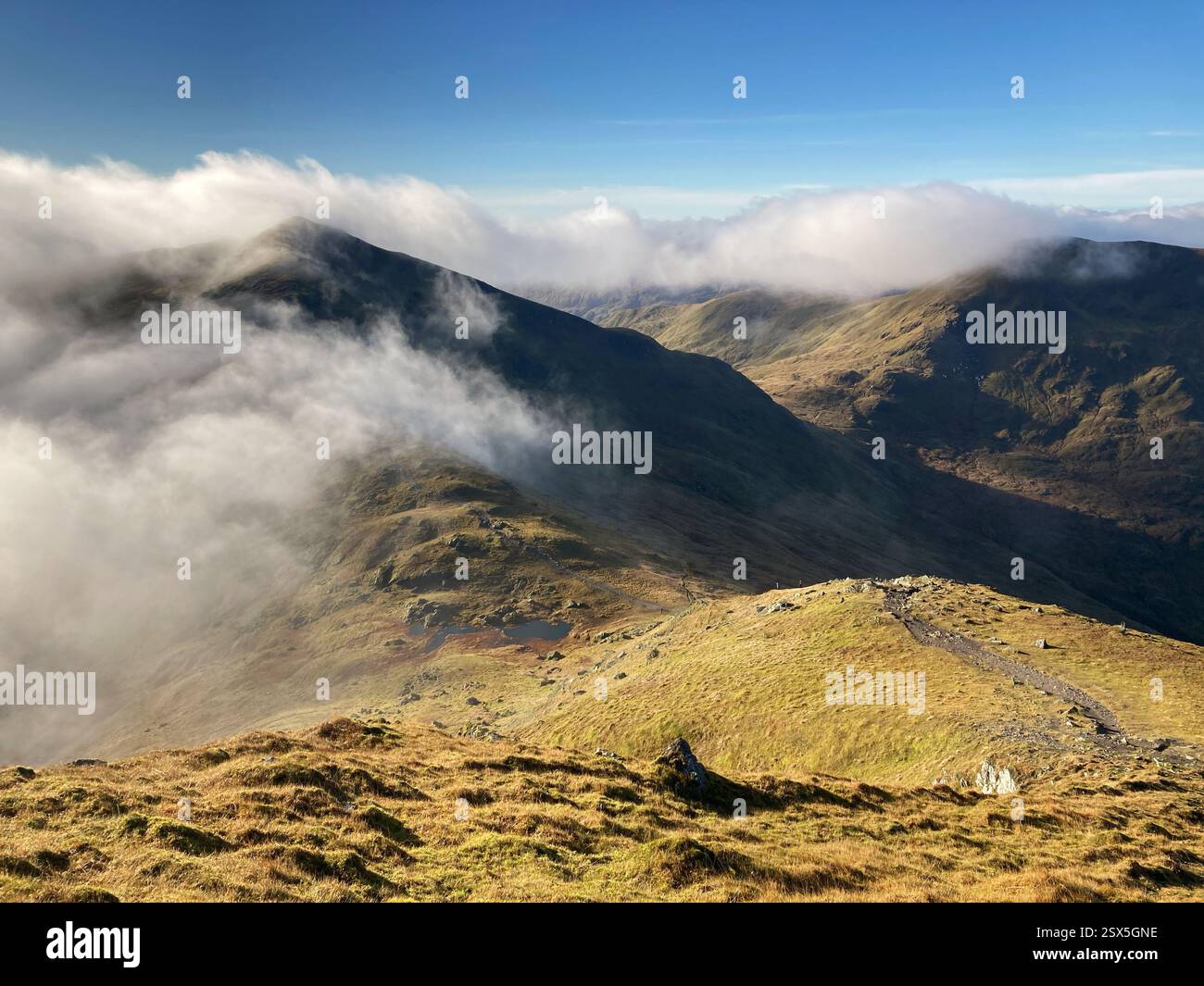View up towards the summit of munro Beinn Ghlas from the slopes of Ben Lawers with a cloud inversion filling the glen, Scotland - Smartphone Captured Stock Image