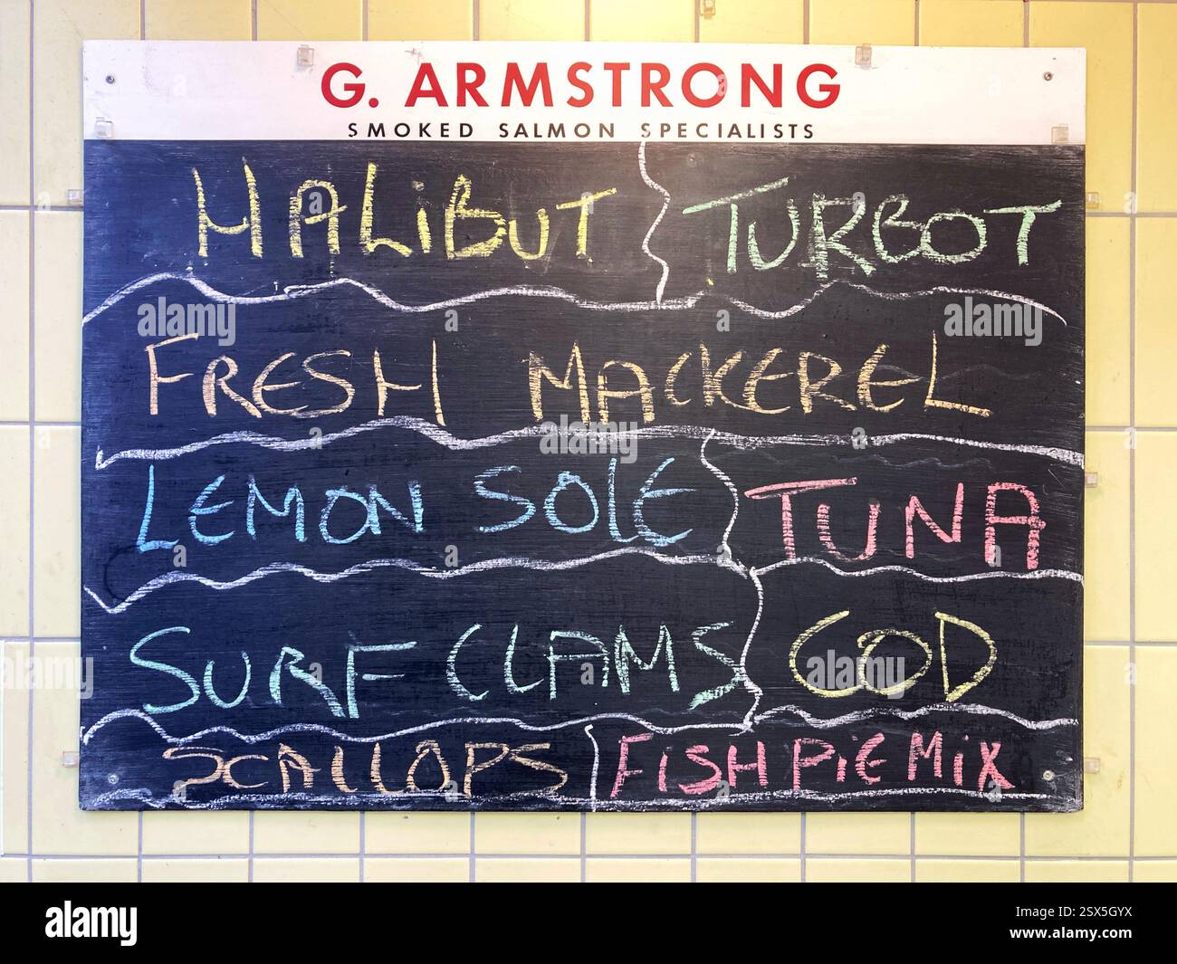 Local Fishmonger blackboard catch of the day with a choice of fish for sale - Smartphone Captured Stock Image