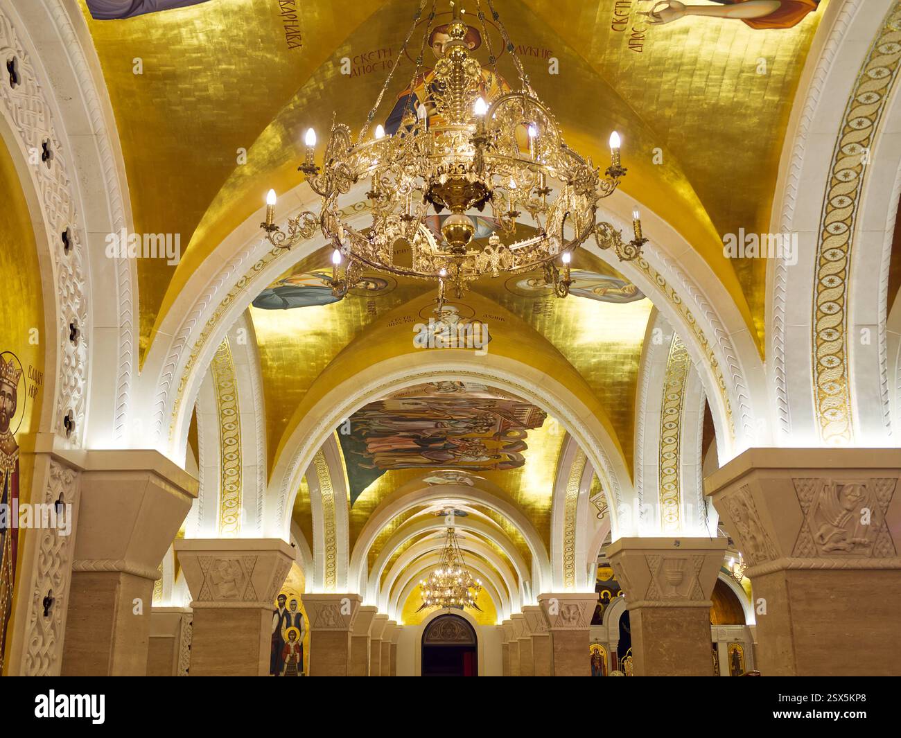 View of Luxurious interior with arched ceilings, ornate chandeliers, and gold ...