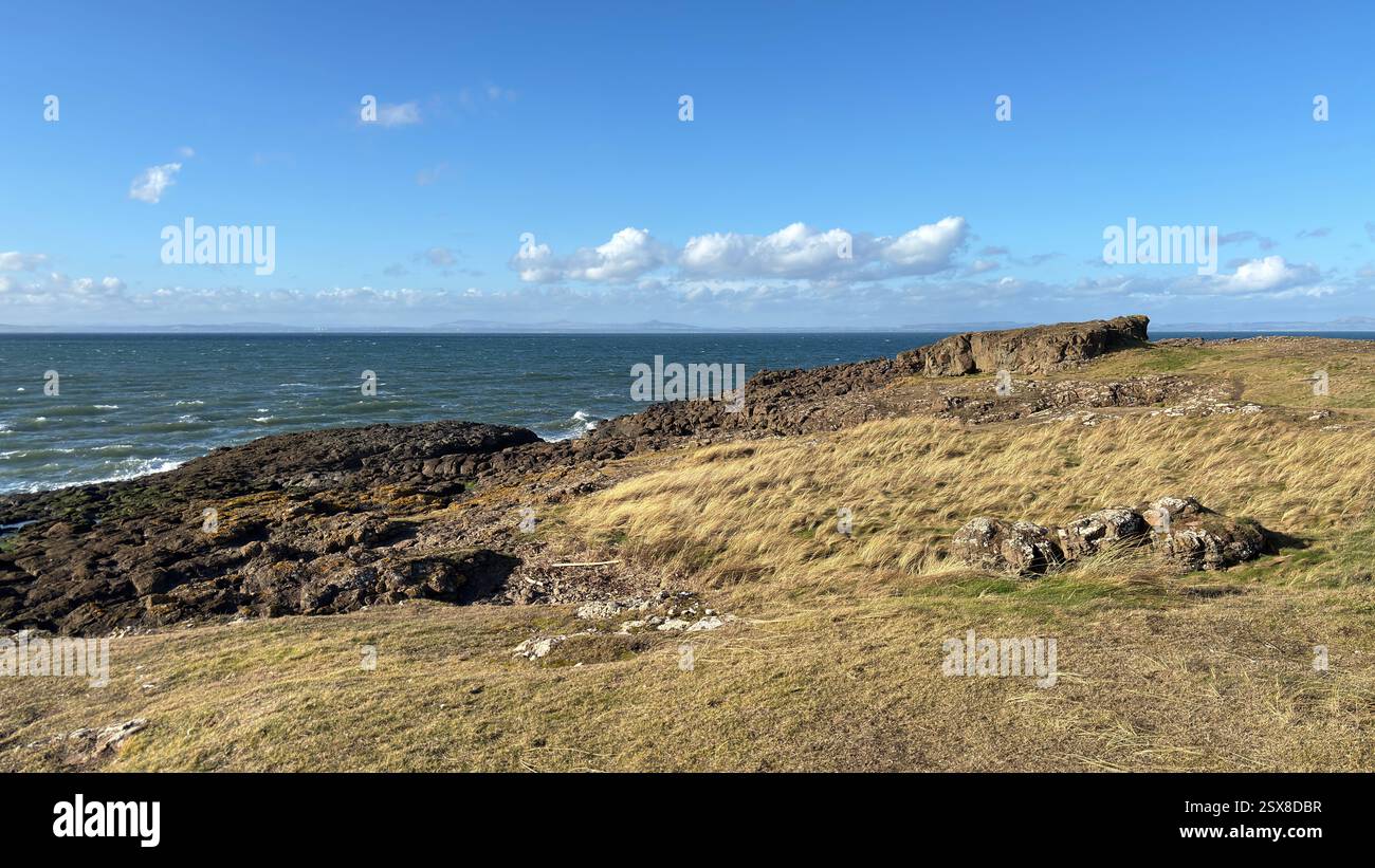 Aberlady Beach near Edinburgh in Scotland. Windswept beach on a bright Spring day. Light clouds, golden sand, sweeping coastline and sea shore - Smartphone Captured Stock Image