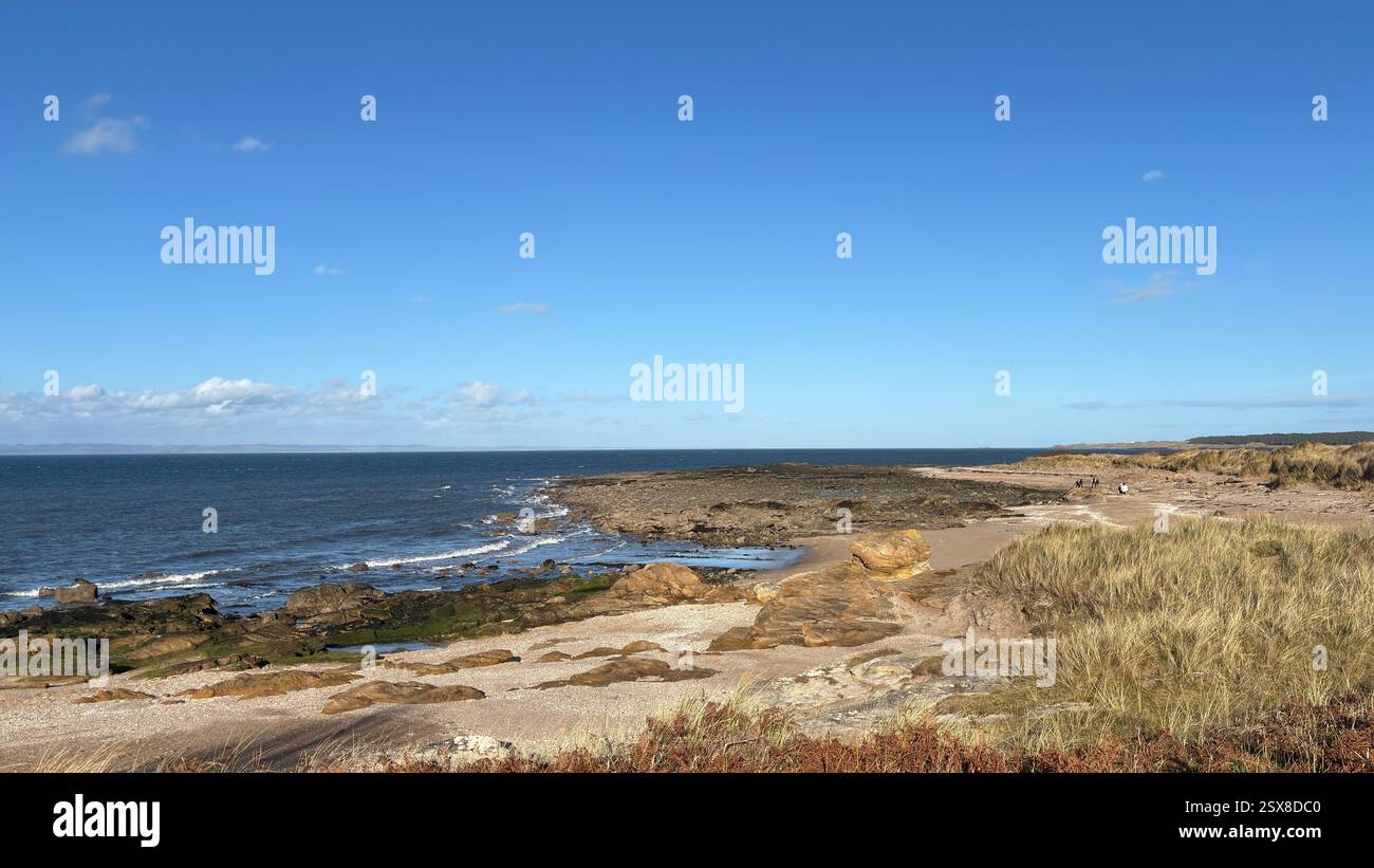 Aberlady Beach near Edinburgh in Scotland. Windswept beach on a bright Spring day. Light clouds, golden sand, sweeping coastline and sea shore - Smartphone Captured Stock Image