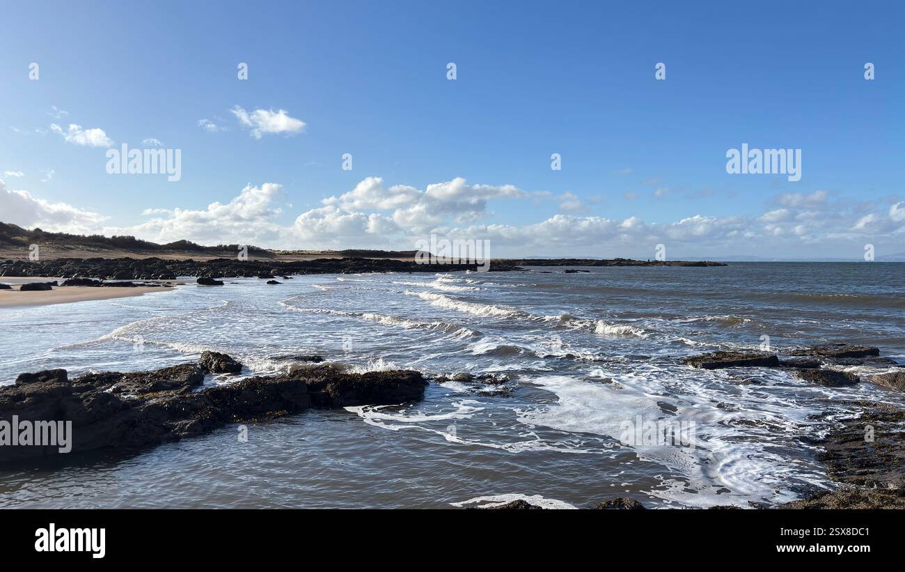 Aberlady Beach near Edinburgh in Scotland. Windswept beach on a bright Spring day. Light clouds, golden sand, sweeping coastline and sea shore - Smartphone Captured Stock Image