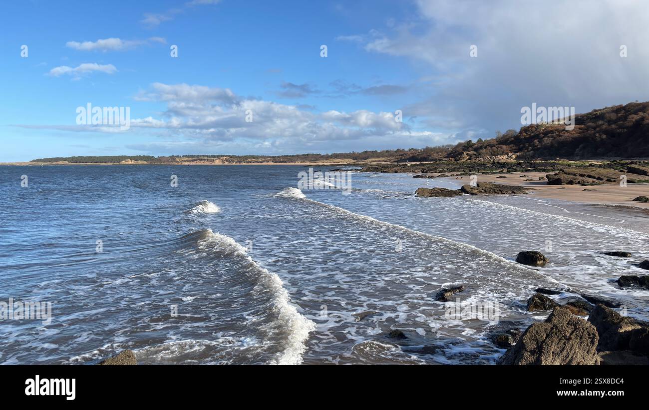 Aberlady Beach near Edinburgh in Scotland. Windswept beach on a bright Spring day. Light clouds, golden sand, sweeping coastline and sea shore - Smartphone Captured Stock Image