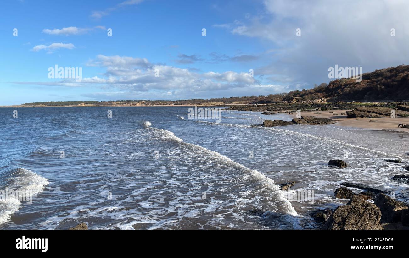 Aberlady Beach near Edinburgh in Scotland. Windswept beach on a bright Spring day. Light clouds, golden sand, sweeping coastline and sea shore - Smartphone Captured Stock Image