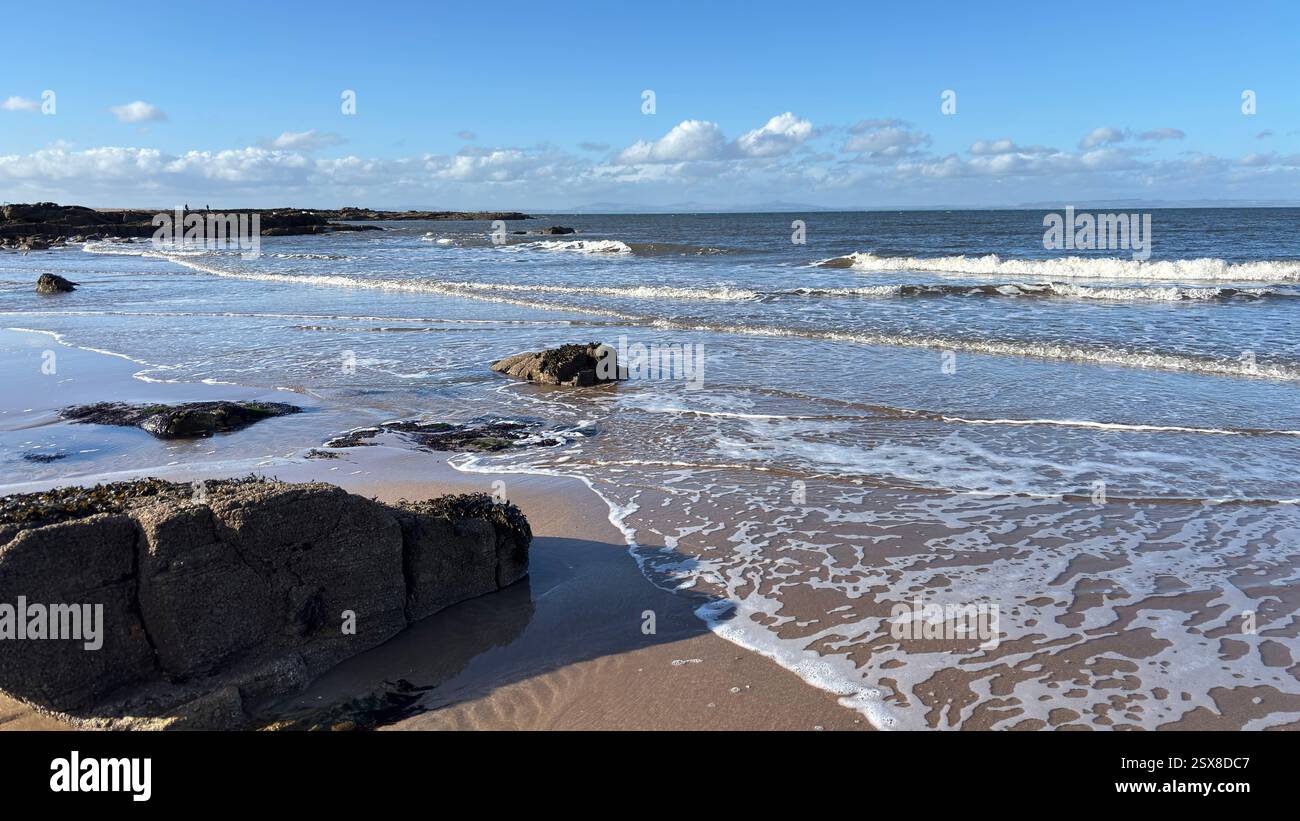 Aberlady Beach near Edinburgh in Scotland. Windswept beach on a bright Spring day. Light clouds, golden sand, sweeping coastline and sea shore - Smartphone Captured Stock Image