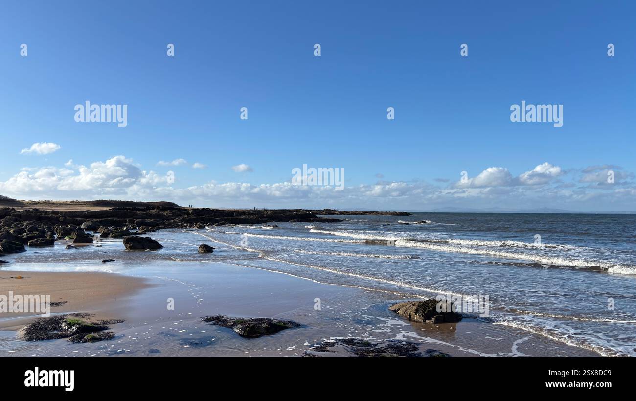 Aberlady Beach near Edinburgh in Scotland. Windswept beach on a bright Spring day. Light clouds, golden sand, sweeping coastline and sea shore - Smartphone Captured Stock Image