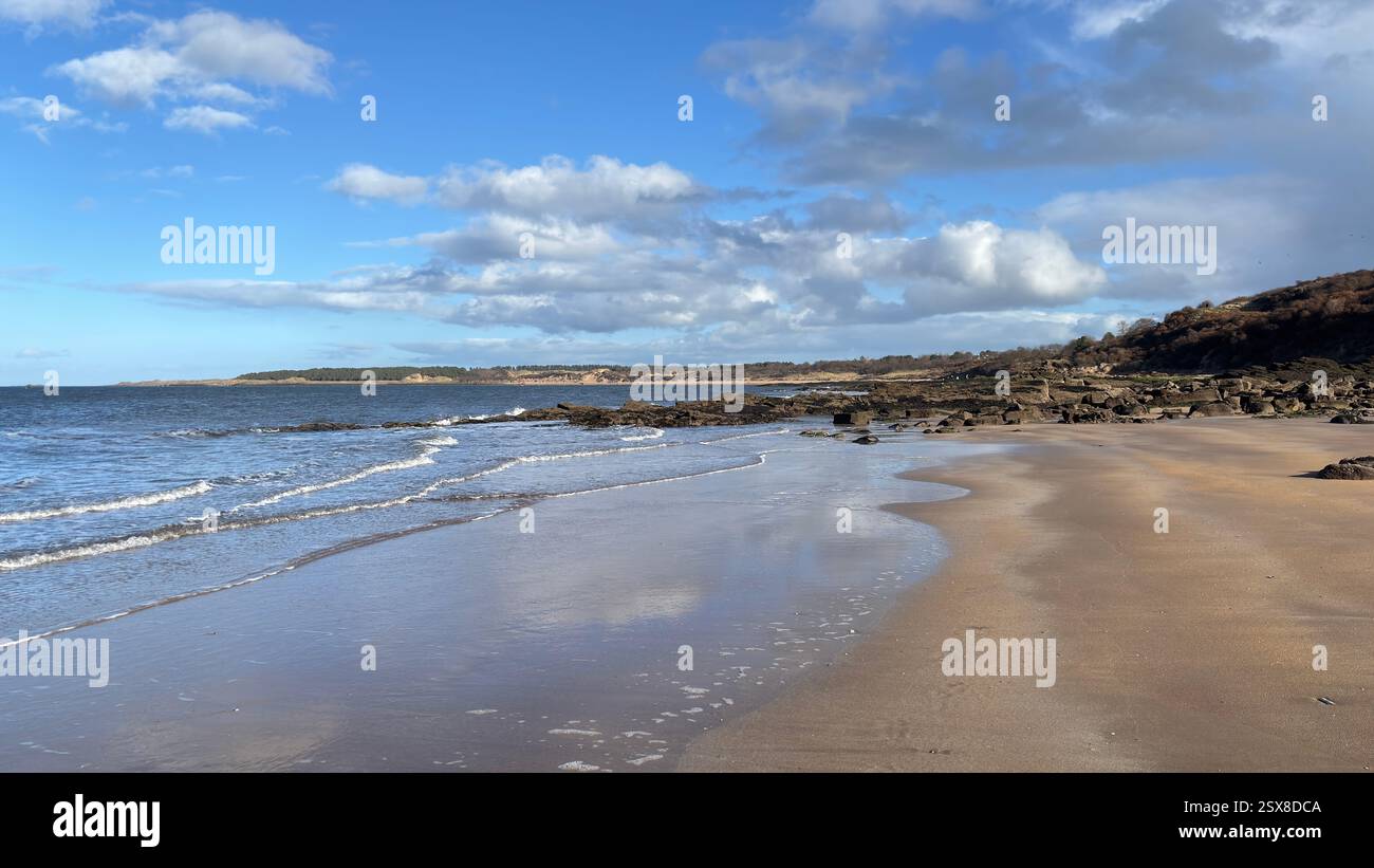 Aberlady Beach near Edinburgh in Scotland. Windswept beach on a bright Spring day. Light clouds, golden sand, sweeping coastline and sea shore - Smartphone Captured Stock Image
