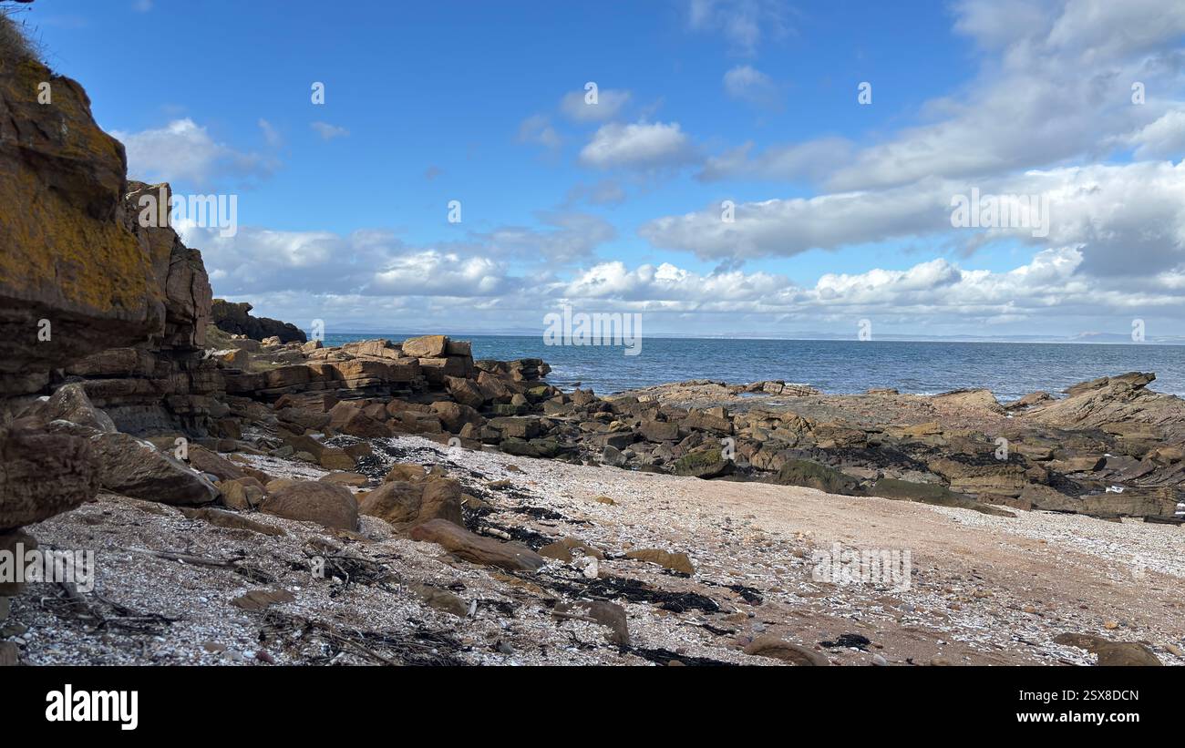 Aberlady Beach near Edinburgh in Scotland. Windswept beach on a bright Spring day. Light clouds, golden sand, sweeping coastline and sea shore - Smartphone Captured Stock Image