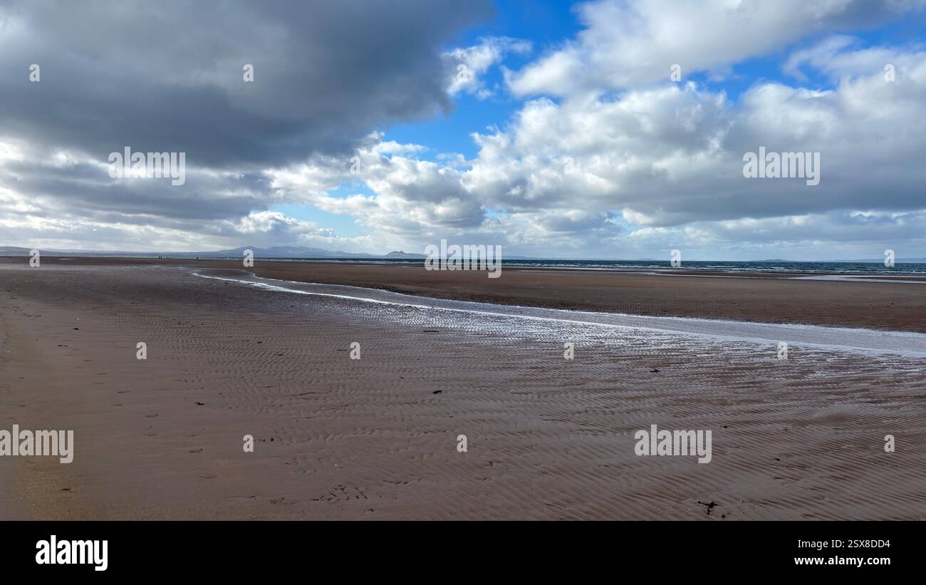 Aberlady Beach near Edinburgh in Scotland. Windswept beach on a bright Spring day. Light clouds, golden sand, sweeping coastline and sea shore - Smartphone Captured Stock Image