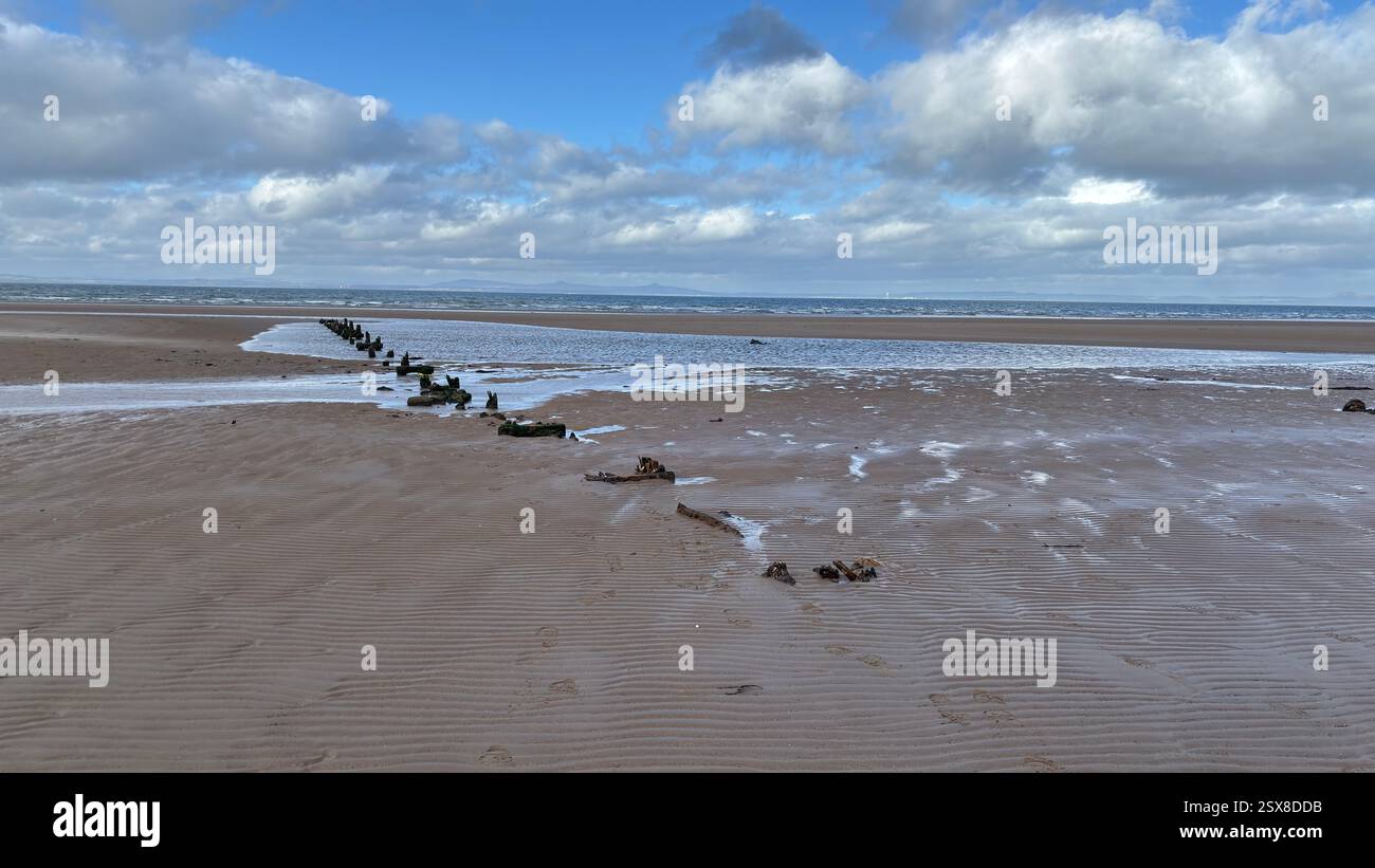 Aberlady Beach near Edinburgh in Scotland. Windswept beach on a bright Spring day. Light clouds, golden sand, sweeping coastline and sea shore - Smartphone Captured Stock Image