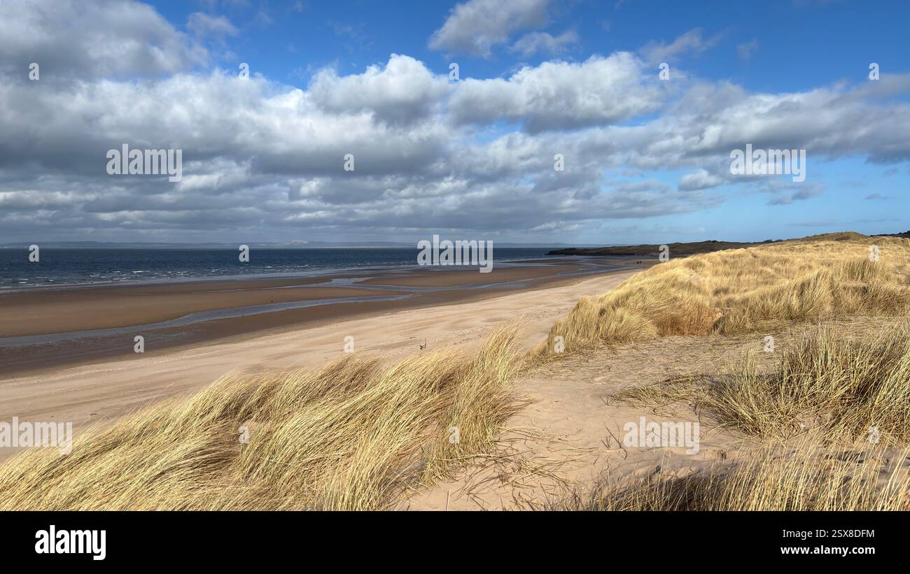 Aberlady Beach near Edinburgh in Scotland. Windswept beach on a bright Spring day. Light clouds, golden sand, sweeping coastline and sea shore - Smartphone Captured Stock Image