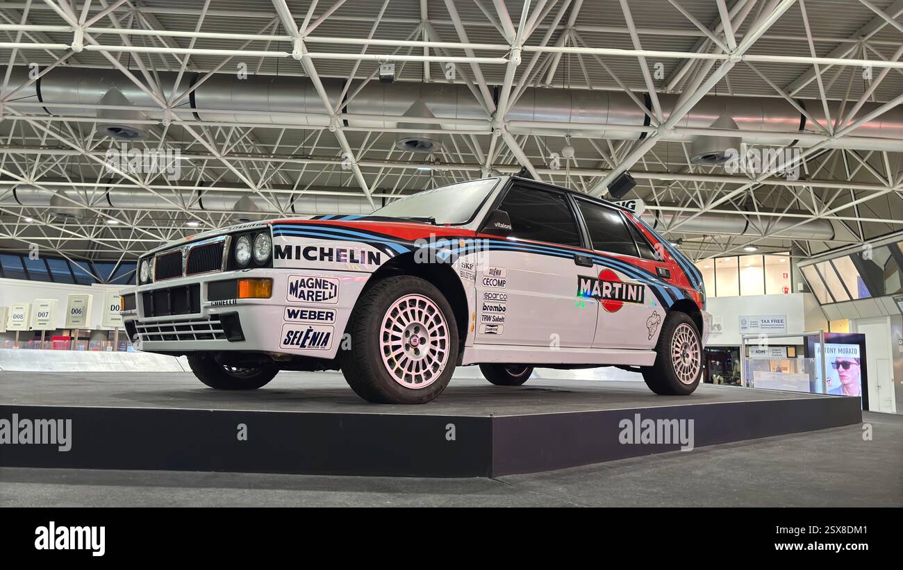 Classic Lancia Delta rally car on display in Turin Airport - Smartphone Captured Stock Image