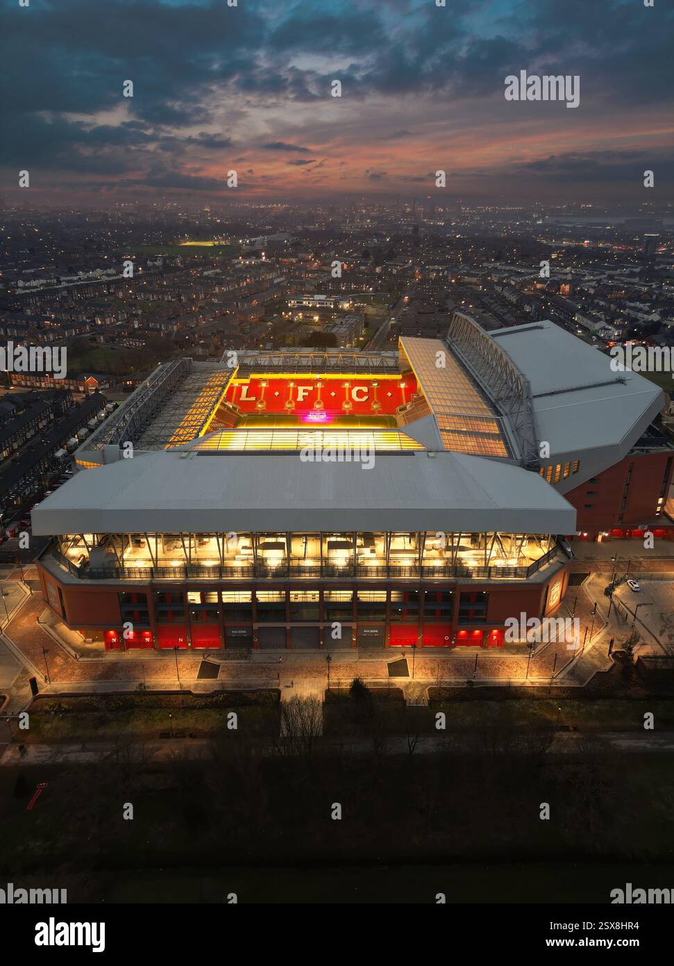 A breathtaking drone shot of Anfield at dusk, with stadium lights ...