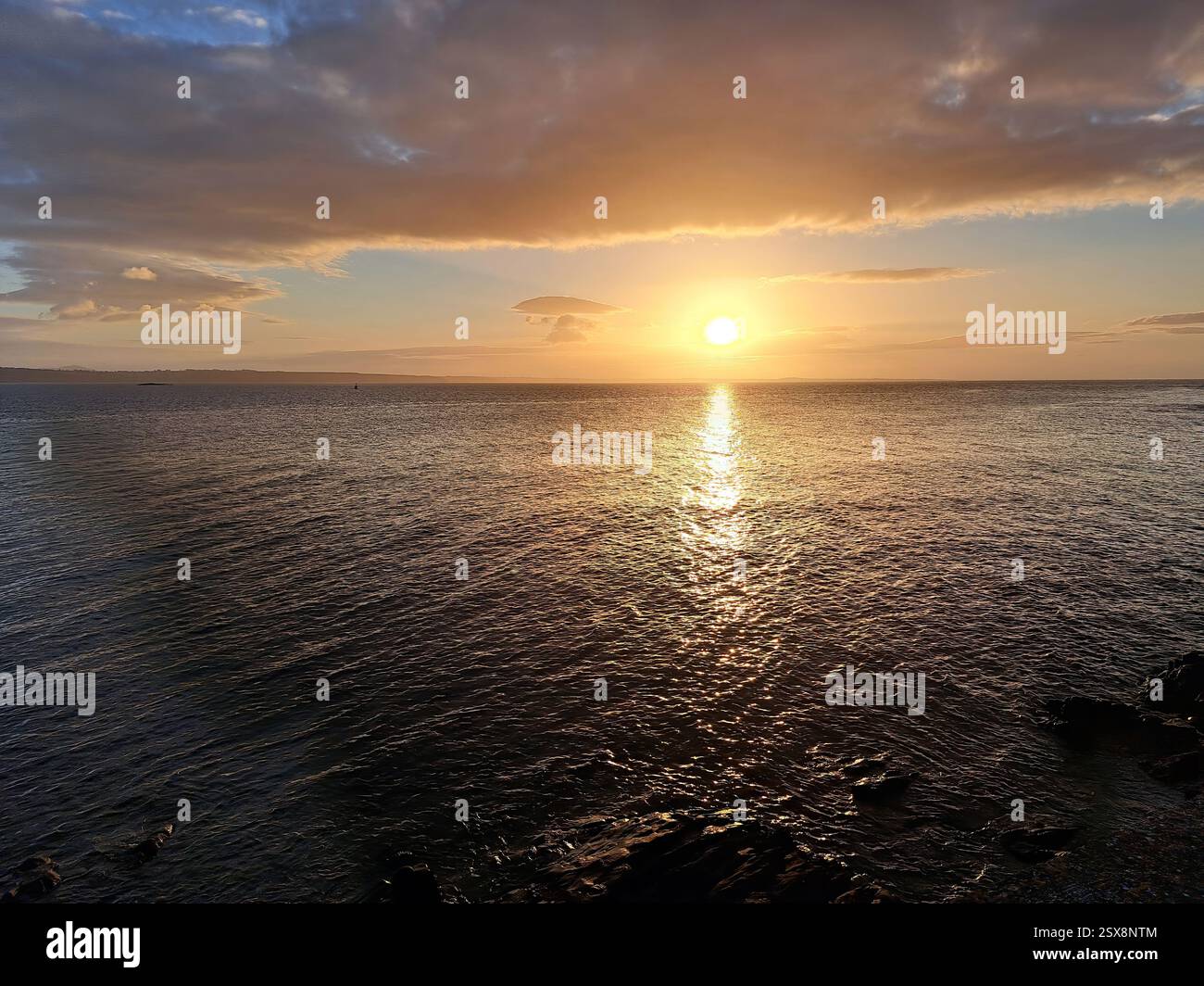 Image of the sunset over atlantic bay i Ireland. - Smartphone Captured Stock Image