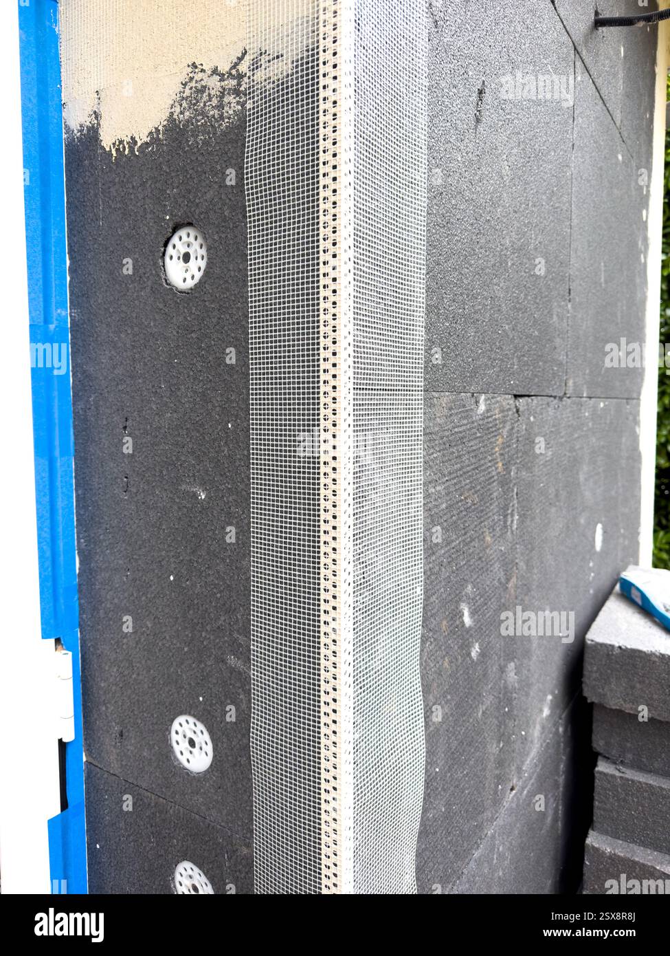 Construction of thermal insulation on a building exterior in progress ...
