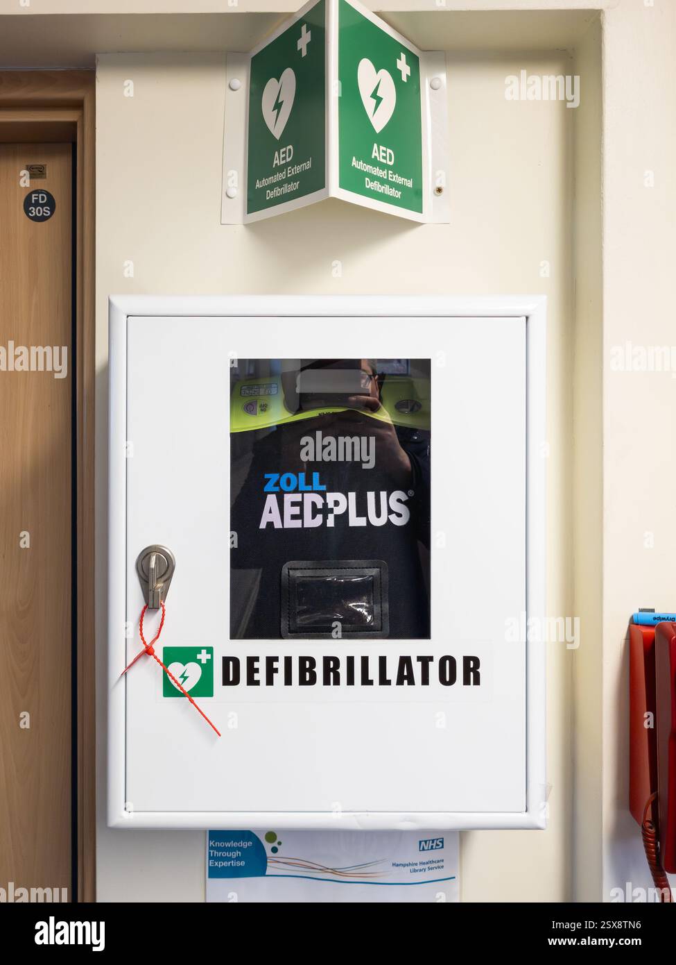 AED (Automated External Defibrillator) at Andover hospital, UK. A defibrillator gives an electric shock to someone's heart who is in cardiac arrest Stock Photo