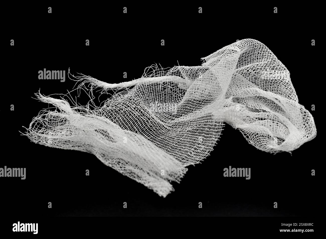 A piece of white medical gauze bandage lies on a black background Stock ...