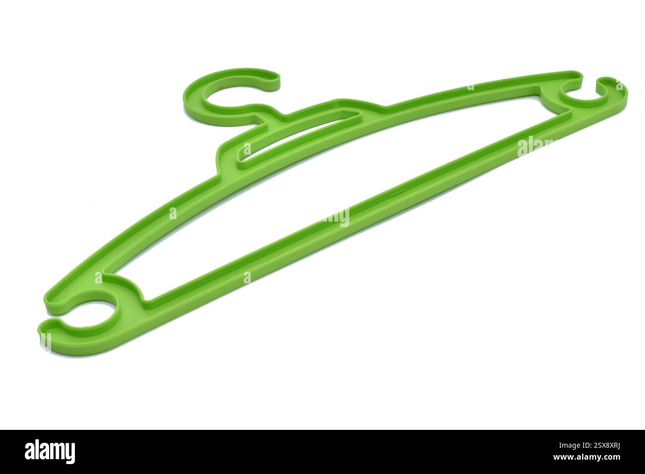 Green plastic clothes hanger on a white background. Stock Photo