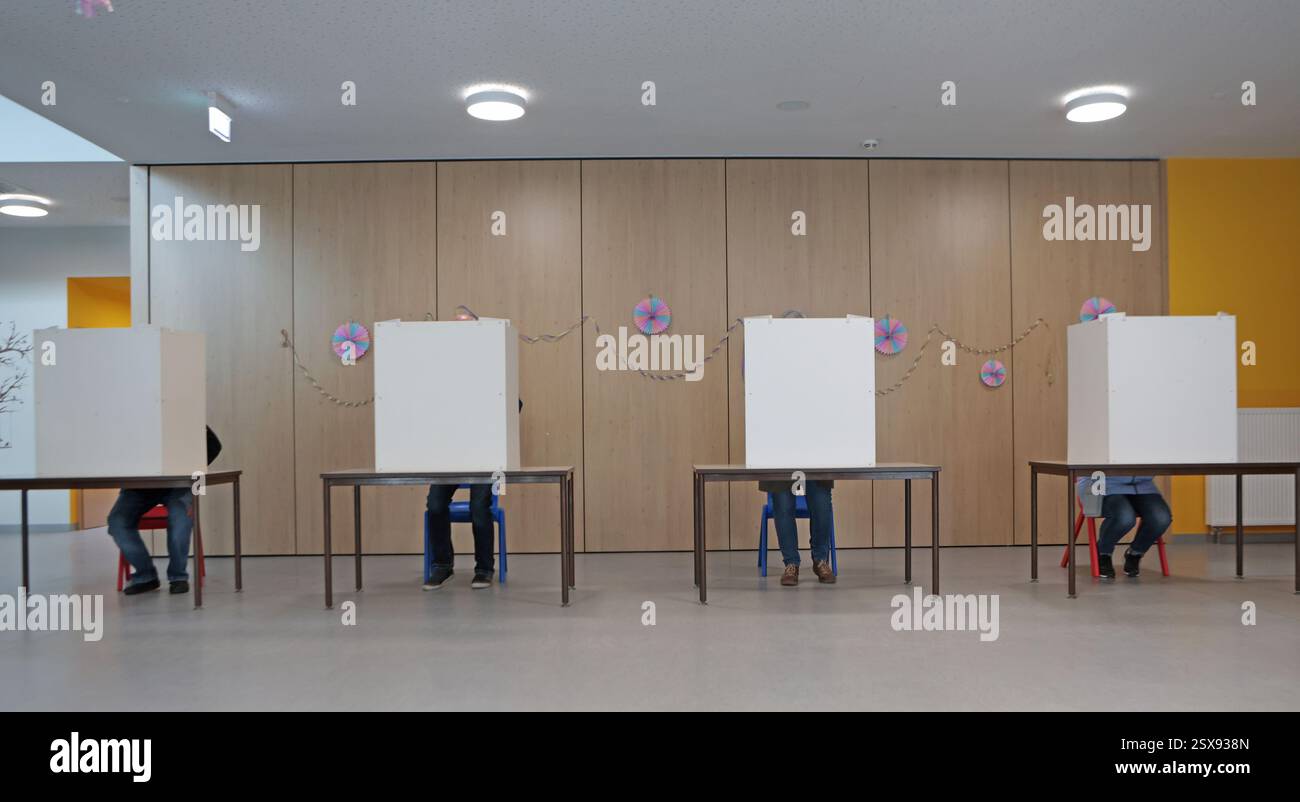 German Polling Wernigerode, Germany. 23rd Feb, 2025. Eligible voters sit in the ...