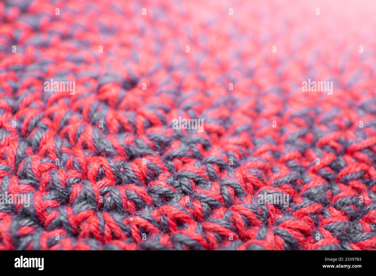 Knitted with a crochet hook, spiral shaped pattern texture, soft focus close up, abstract   backdrop Stock Photo