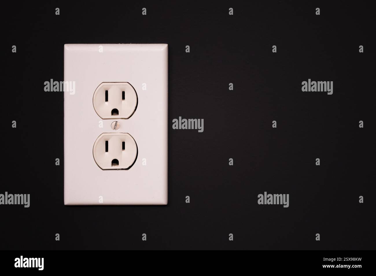 White duplex outlet on a slate gray wall with copy space Stock Photo