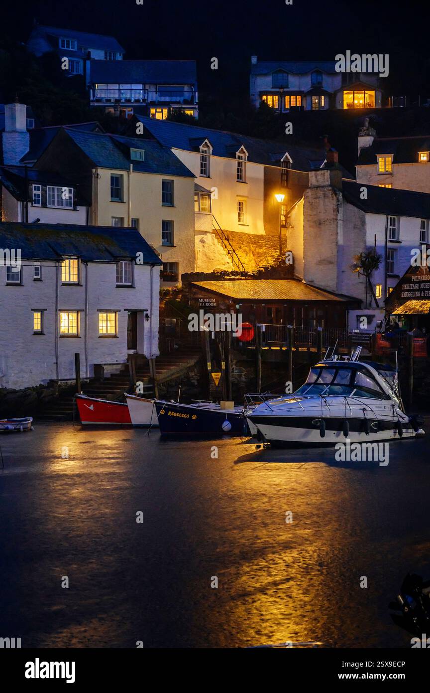 Polperro harbour with moored boats at dusk on a rainy November evening, Polperro, Cornwall, Uk Stock Photo
