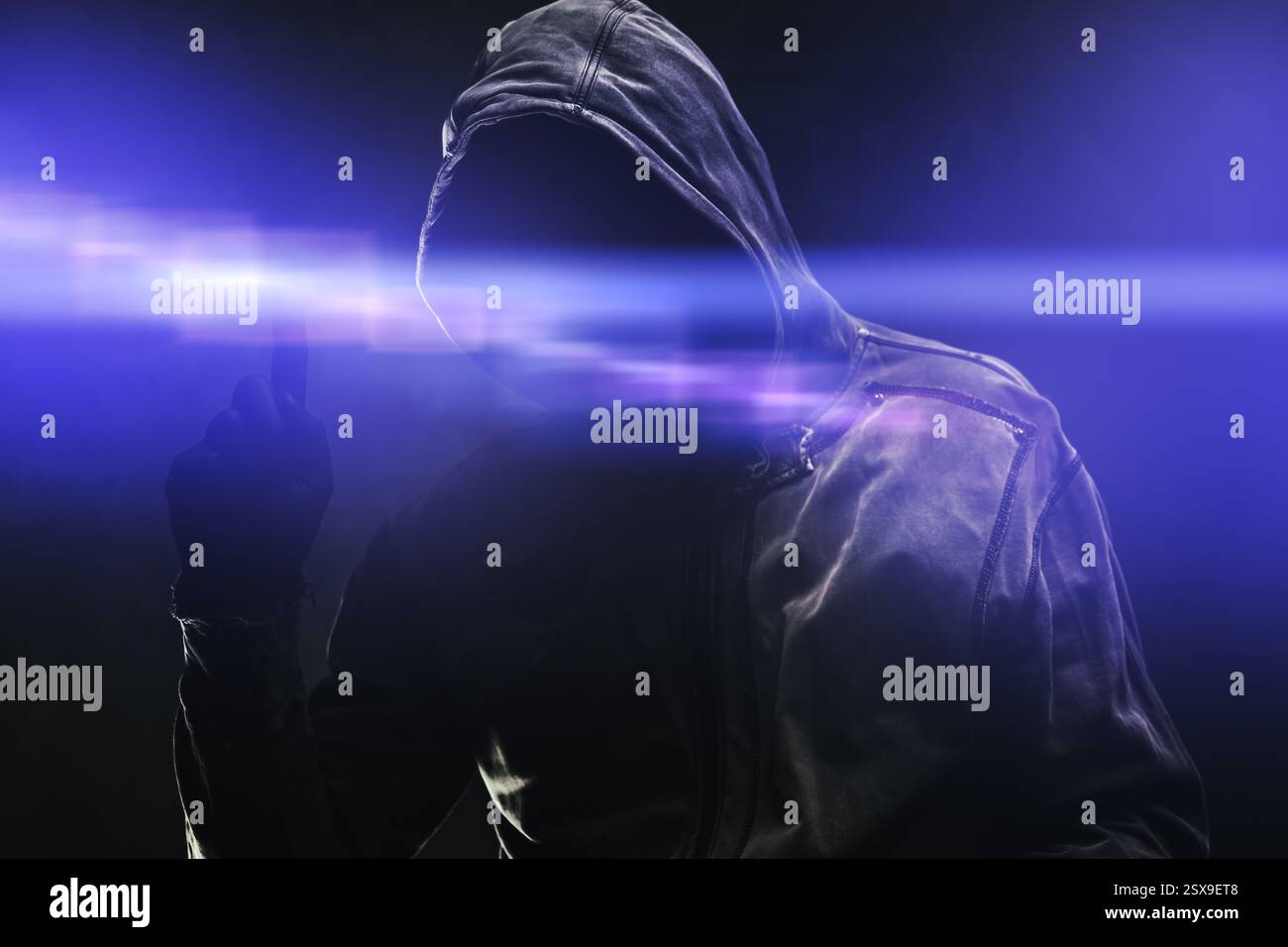Computer hacker in hoodie using virtual screen. Database hacking, computer virus malware and cybersecurity concept. Selective focus. Stock Photo