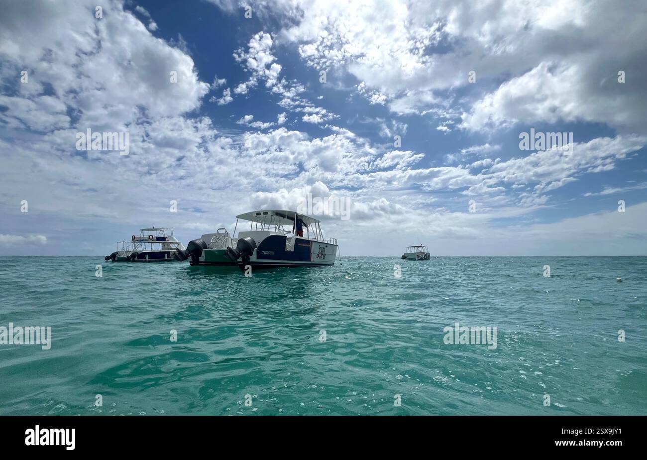 Boats resting in the Caribbean Sea under the sunny sky with white clouds - Smartphone Captured Stock Image