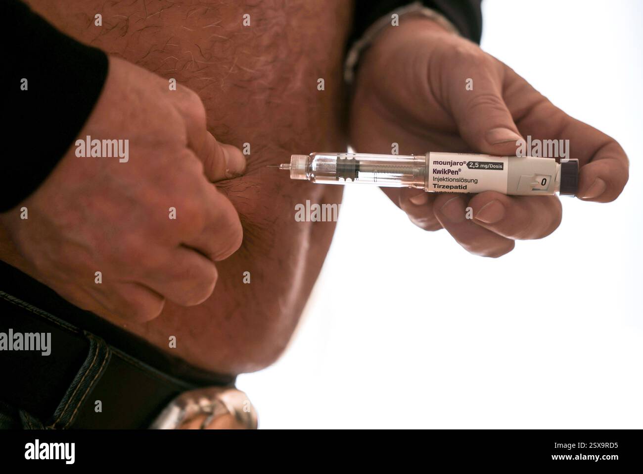 Cologne, Germany. 03rd Feb, 2025. ILLUSTRATION - A man takes the weight ...