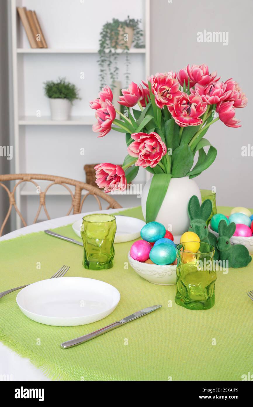 Beautiful table serving with red tulips for Easter celebration Stock Photo