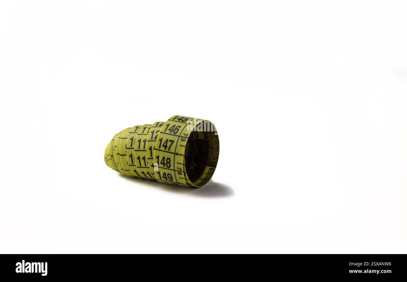 Tailor's measuring tape in a roll on a white background. Stock Photo