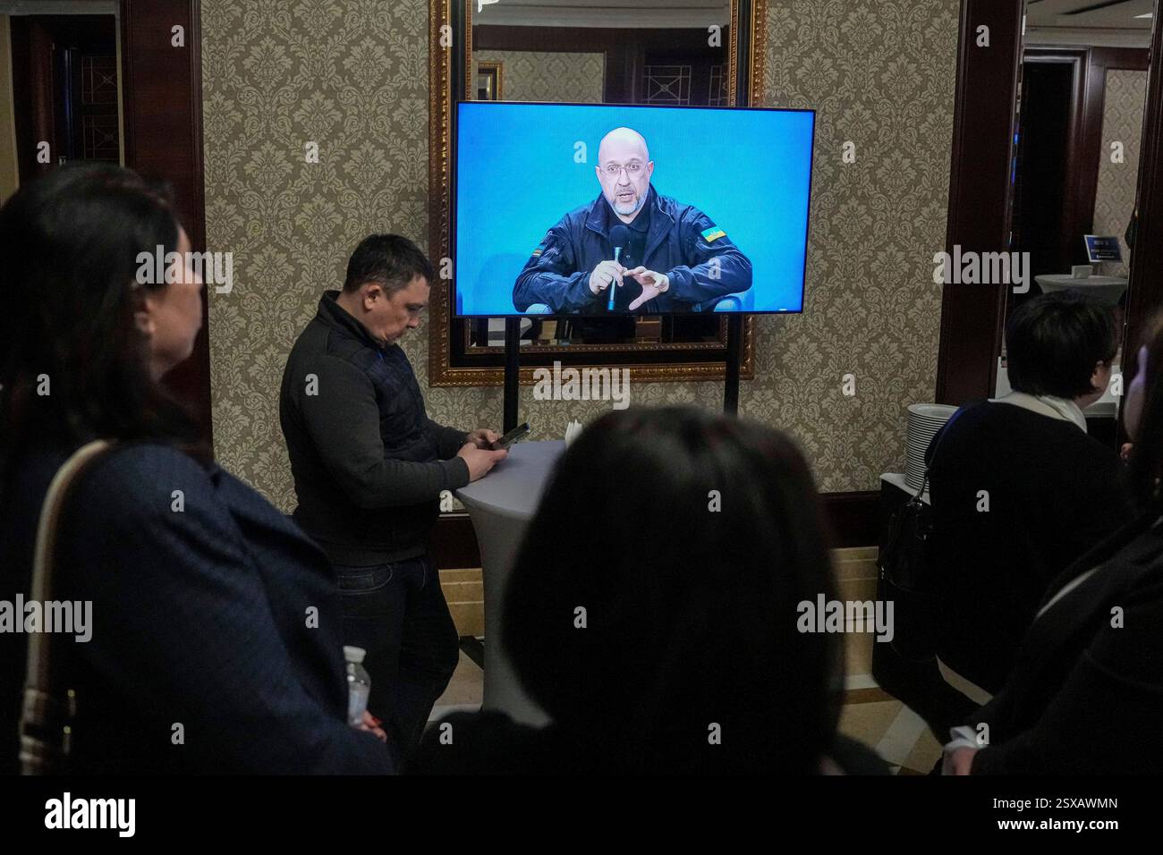 Prime Minister of Ukraine Denys Shmyhal is seen on a screen during ...