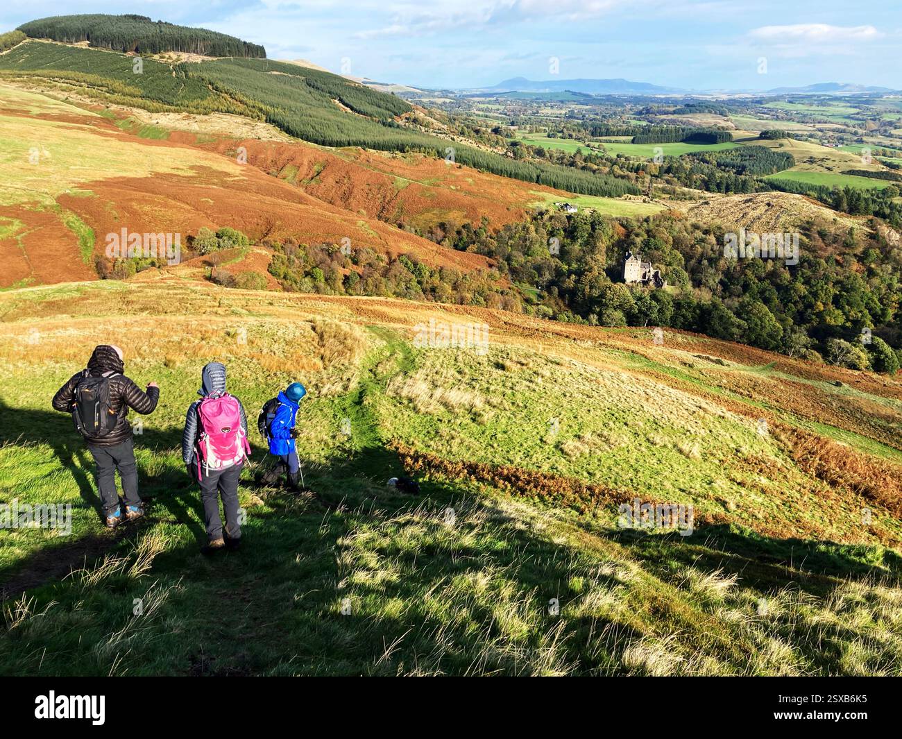 Walkers on the trail high above Dollar Glen and Castle Campbell on the Ochil Hills with a view of the Forth Valley, Clackmannanshire, Scotland - Smartphone Captured Stock Image