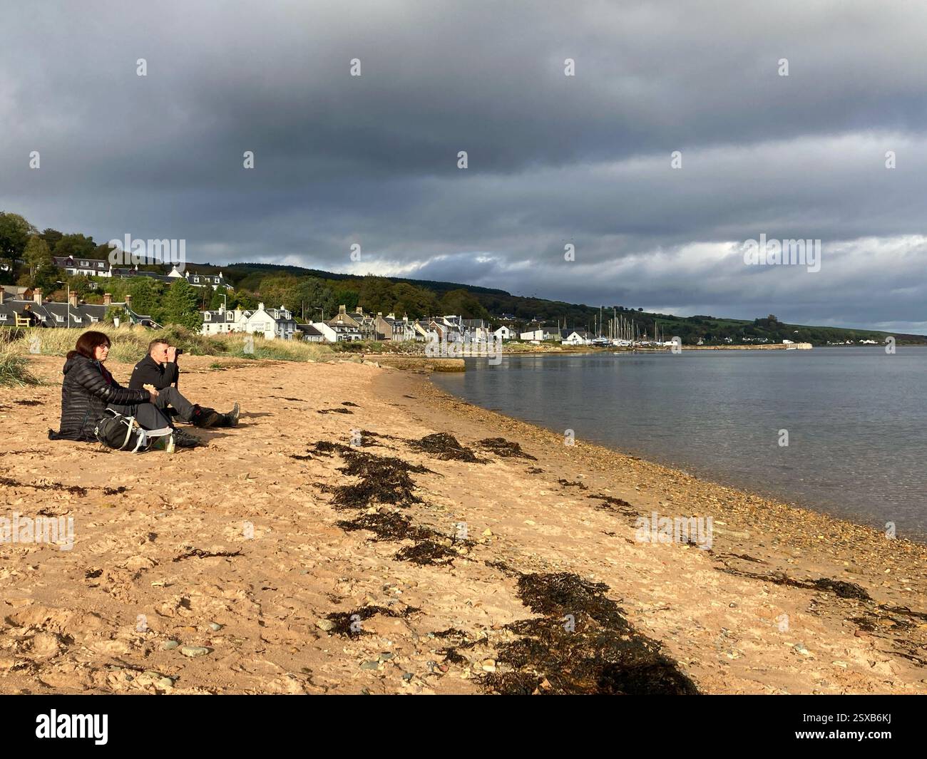 Sitting on the beach at Lamlash bay, Isle of Arran, Firth of Clyde, Scotland - Smartphone Captured Stock Image