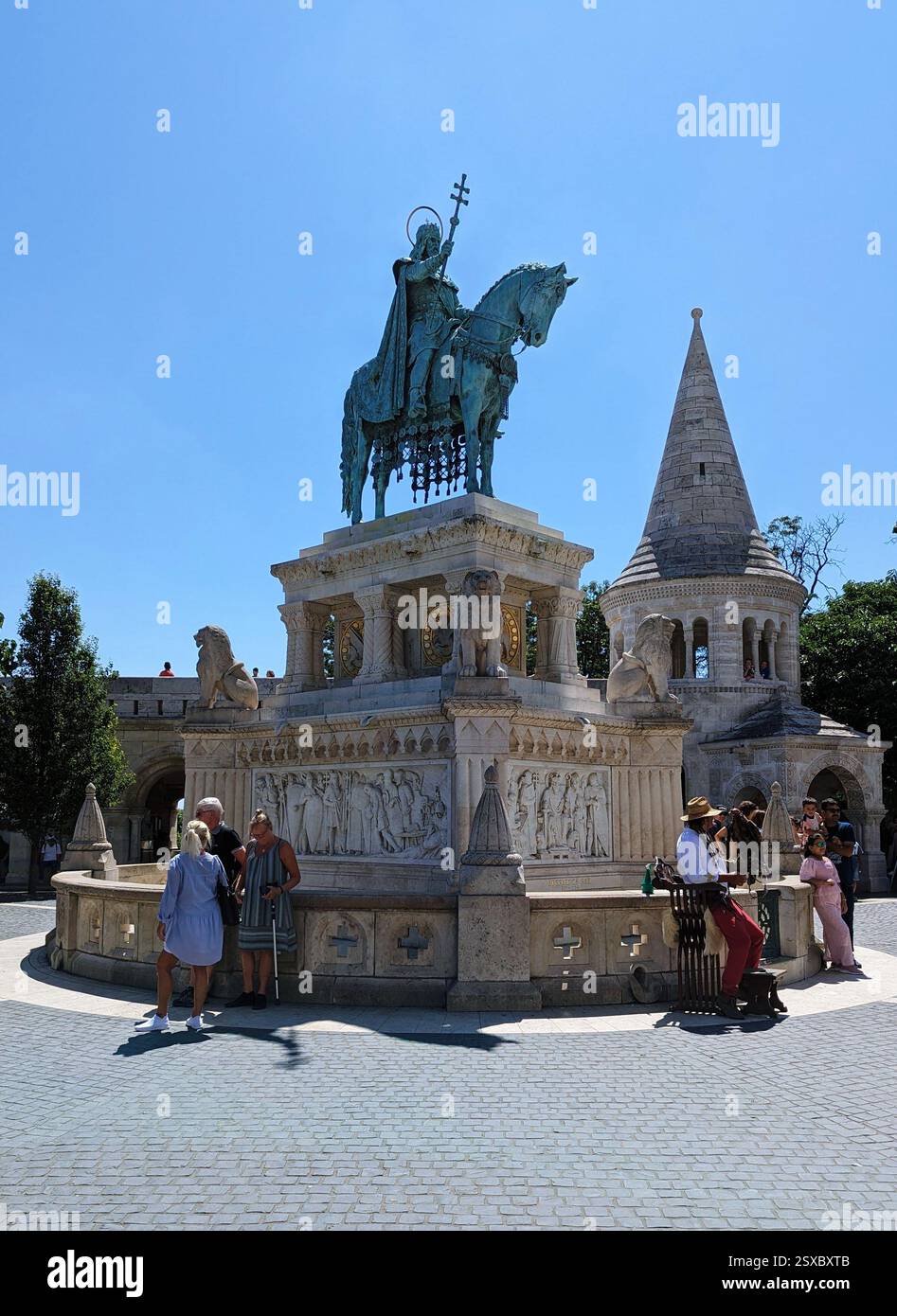 Statue of St. Stephen I at Fisherman’s Bastion. The bronze equestrian statue stands on a decorated pedestal, surrounded by tourists and history. - Smartphone Captured Stock Image
