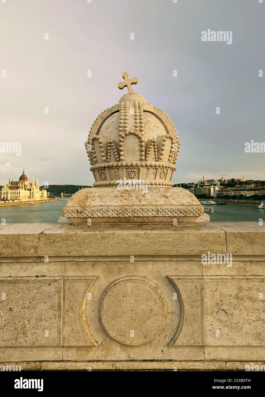 Stone crown detail on Budapest's Margaret Bridge, with the Hungarian Parliament and Danube River in the background—a stunning view of the city’s herit. - Smartphone Captured Stock Image