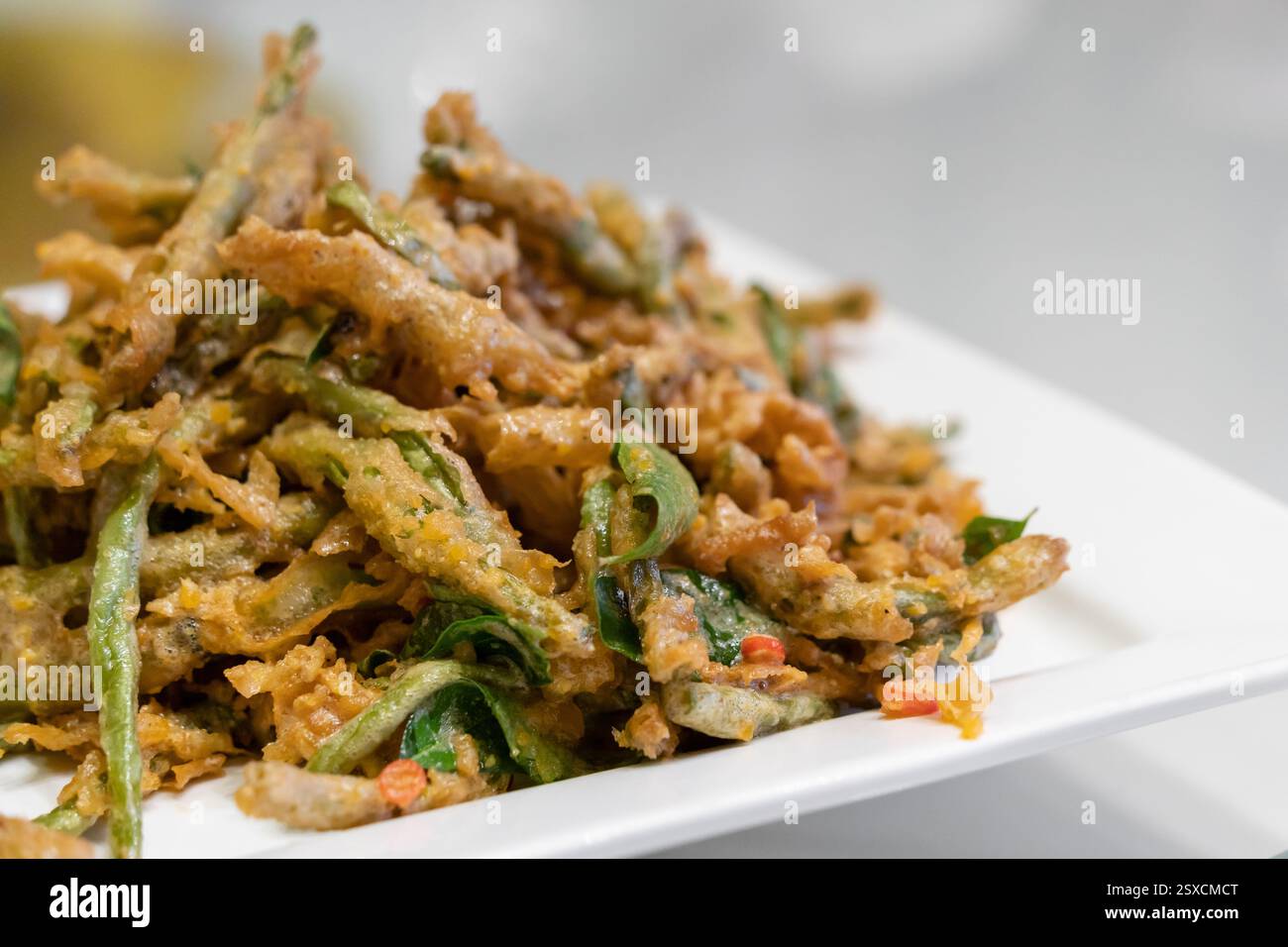 Deep fried french beans with salted duck egg yolk Stock Photo
