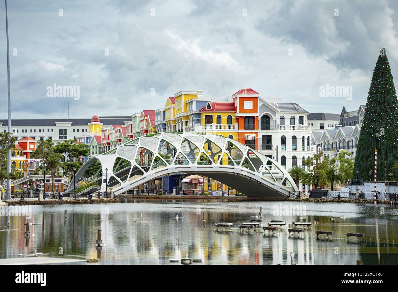 A modern bridge with colorful buildings and festive decorations along ...